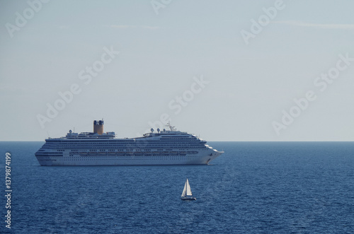 Mega family cruiseship cruise ship liner Fortuna anchored offshore of Civitavecchia Rome, Italy before reactived after Covid pandemic with other vessels in port and coastline