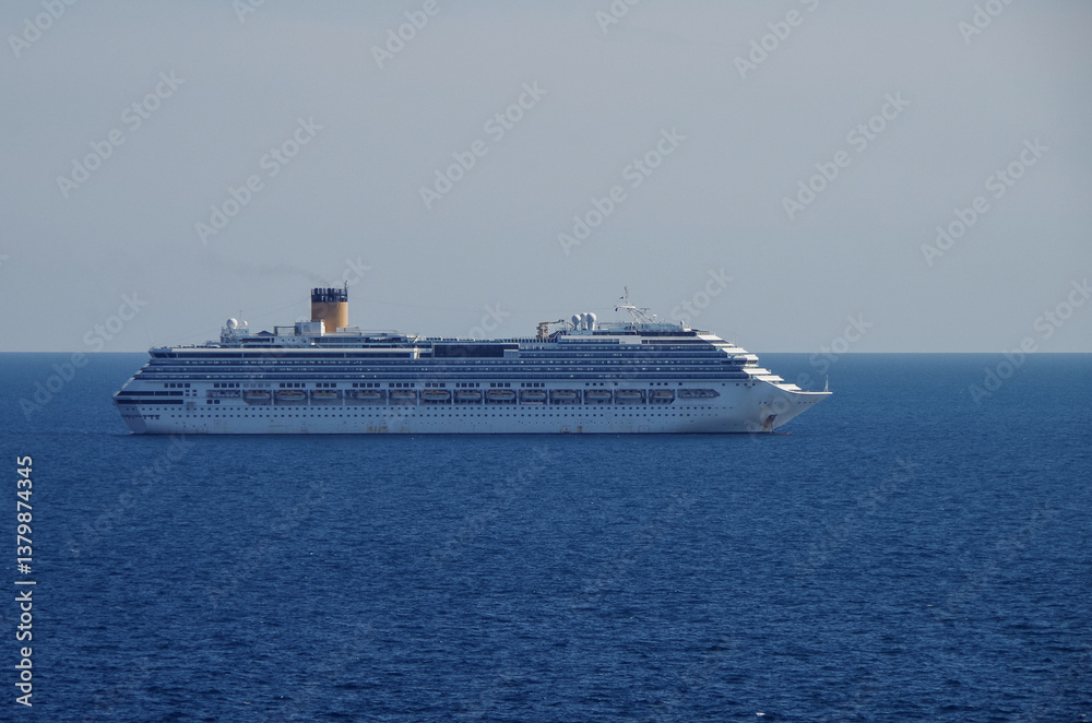 Mega family cruiseship cruise ship liner Pacifica anchored offshore of Civitavecchia Rome, Italy before reactived after Covid pandemic with other vessels in port and coastline