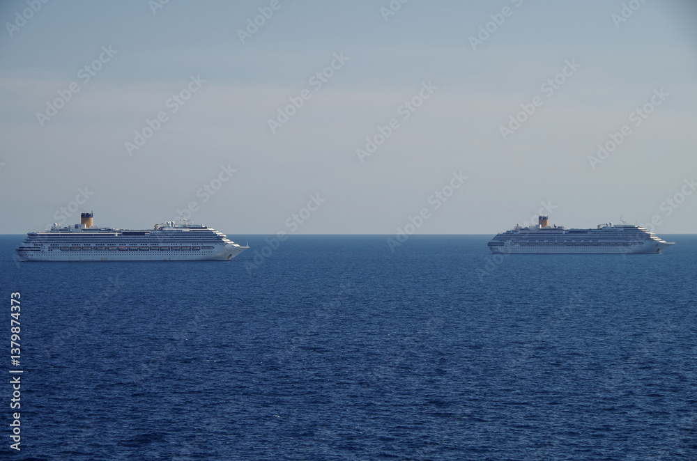 Mega family cruiseship cruise ship liner Fortuna anchored offshore of Civitavecchia Rome, Italy before reactived after Covid pandemic with other vessels in port and coastline