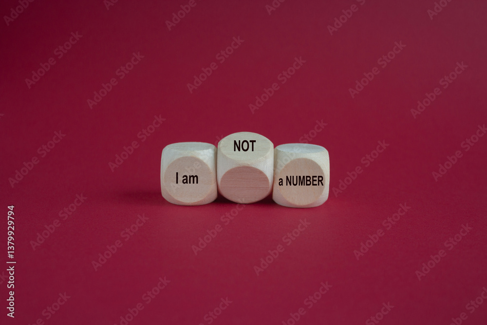 Wooden cubes form the expression I am not a number. Beautiful red background. Business your opinion matters concept.