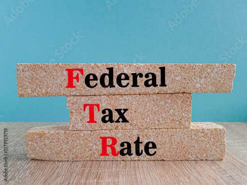 Obraz na płótnie Federal tax rates symbol. Concept words Federal tax rates on brick blocks. Beautiful wooden table, blue background. Business concept. Copy space w salonie