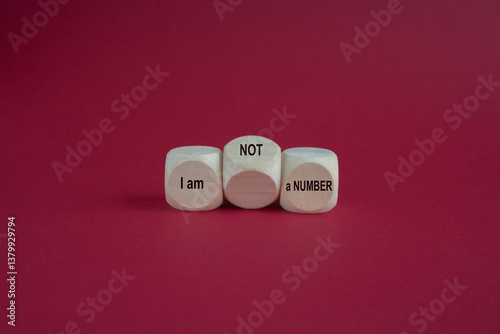 Obraz na płótnie Wooden cubes form the expression I am not a number. Beautiful red background. Business your opinion matters concept. w salonie