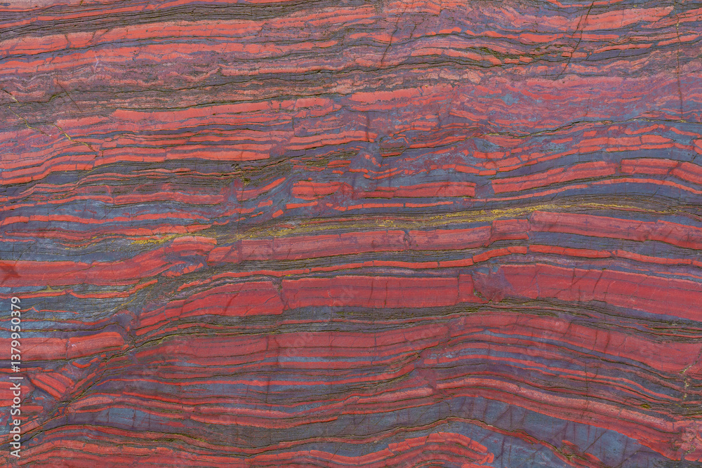 Faceted red stone with natural patterns and texture. Banded iron ore. Mineral structure, geological layers, natural background for design. Faceted red stone with natural patterns and texture. Banded iron ore. Mineral structure, geological layers, natural background for design.