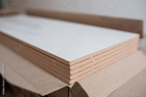 Stack of new ceramic tiles in packaging - material for wall and floor covering