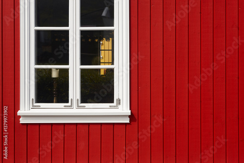 Picturesque red wooden facade and white window. Iceland traditional architecture