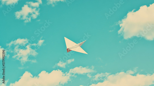 paper plane flying in cloudy background
