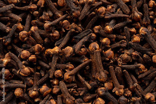 Fototapeta Naklejka Na Ścianę i Meble -  Clove spice textured background. Dry carnation spicy buds pattern, natural Indian clove condiment