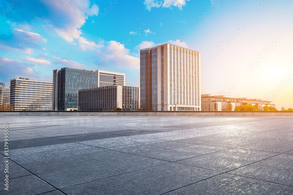 Empty square floor with modern cityscape and office buildings background during sunrise