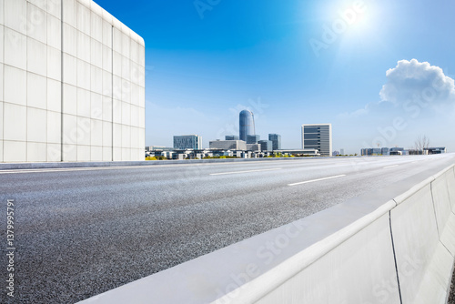 Obraz na płótnie Empty asphalt road and city skyline with modern buildings scenery under a sunny blue sky w salonie