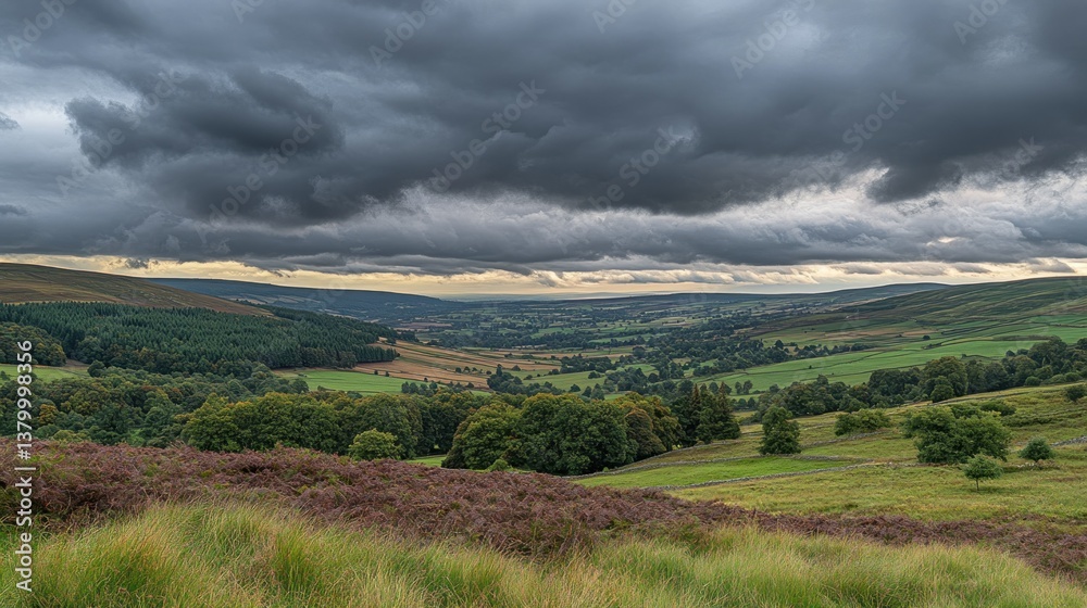 Naklejka premium Dramatic landscape under dark stormy clouds over rolling countryside views