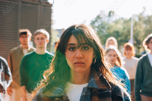 Young woman leading group of students outdoors