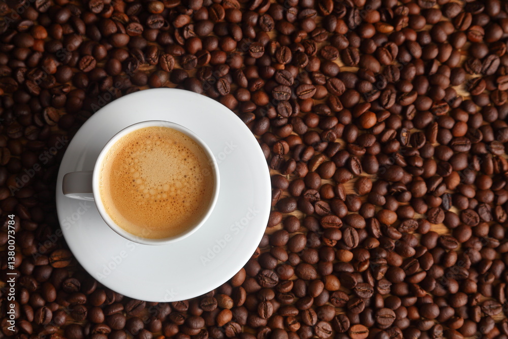 Top view of Espresso in a White Cup on Toasted Coffee Bean Background Top view of Espresso in a White Cup on Toasted Coffee Bean Background