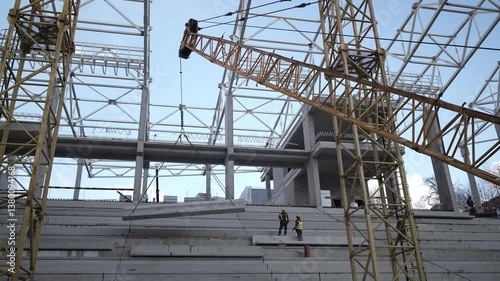 The Ongoing Construction Progress of a Modern Structure Using Cranes