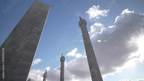 Majestic Concrete Monuments Standing Proudly Under a Sunlit Sky Above