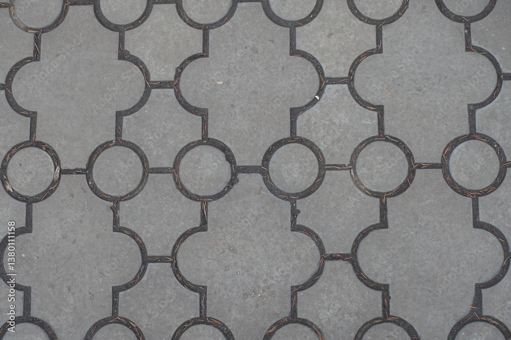 Close shot of pavement of curved gray interlocking concrete tiles