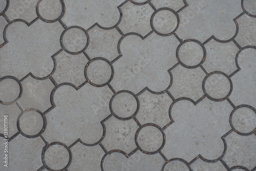 Obraz na płótnie Close view of pavement of curved gray interlocking concrete tiles w salonie