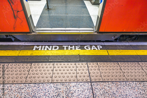 Mind the Gap Warning on London Underground Train Platform with Open Door
