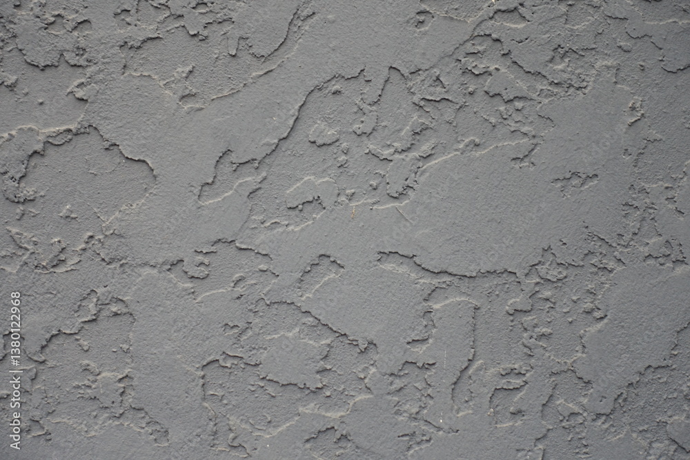 Close shot of gray wall with troweled dash stucco finish