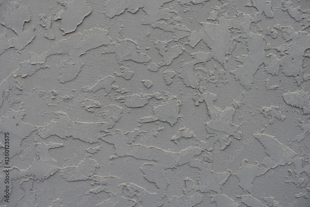Closeup of gray wall with troweled dash stucco finish
