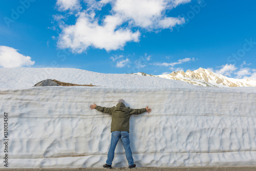 Wallpaper Mural Man Leaning on a Snow Wall with Arms Outstretched in Uri, switzerland. Torontodigital.ca