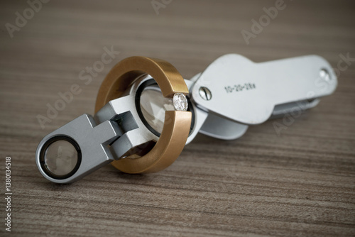 Jewelry Loupe and Diamond Ring on Wood table in Switzerland.