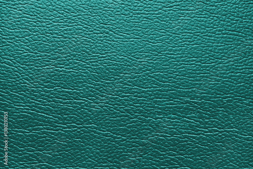 Glossy structure of genuine leather, natural skin surface with embossing pattern. Artifical turquoise colored leatharette close up, macro texture. Background, wallpaper, backdrop.
