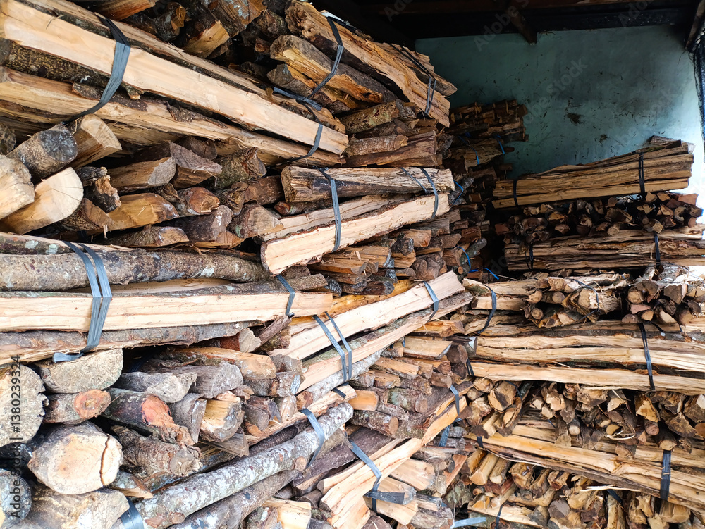 pile of stacked firewood stored in a shed. bundle of stack firewood for home personal use and displayed for sale. pile of stacked firewood stored in a shed. bundle of stack firewood for home personal use and displayed for sale.
