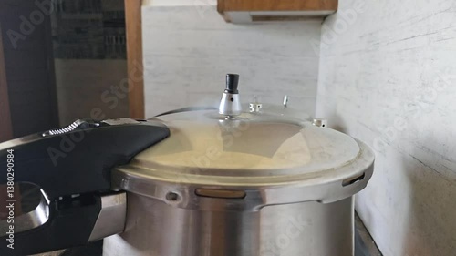 A pressure regulator weight on a pressure cooker lid. 