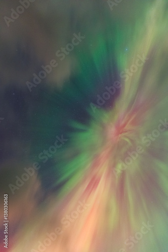 Obraz na płótnie The Northern Lights dance over the Isle of Skye, painting the night sky in vibrant greens and purples. A magical display above Scotland’s rugged landscapes. w salonie