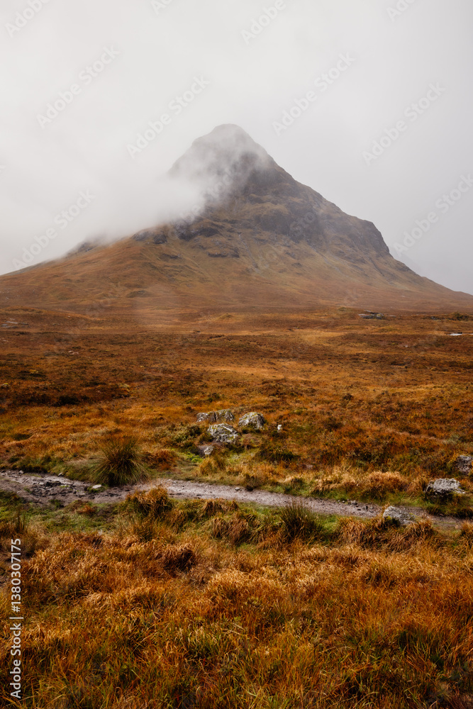 Golden heather blankets the Scottish Highlands, where misty peaks rise above deep glens and serene lochs. Autumn’s glow paints a landscape of wild, untamed beauty.