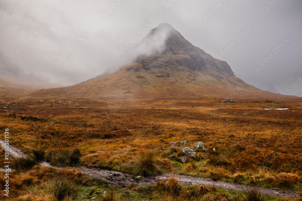Golden heather blankets the Scottish Highlands, where misty peaks rise above deep glens and serene lochs. Autumn’s glow paints a landscape of wild, untamed beauty.