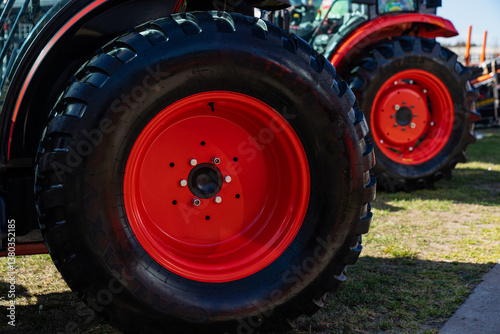Massive industrial orange rim tractor tires. Tractor expo tyre close up