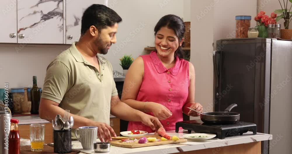 Husband and wife chopping and sauteing vegetables in pan Husband and wife chopping and sauteing vegetables in pan