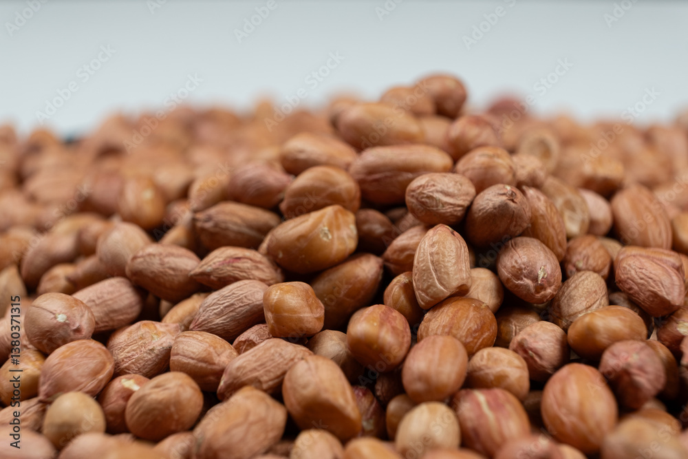 Peanut background, lots of raw peeled brown peanuts close-up. Peanut background, lots of raw peeled brown peanuts close-up.