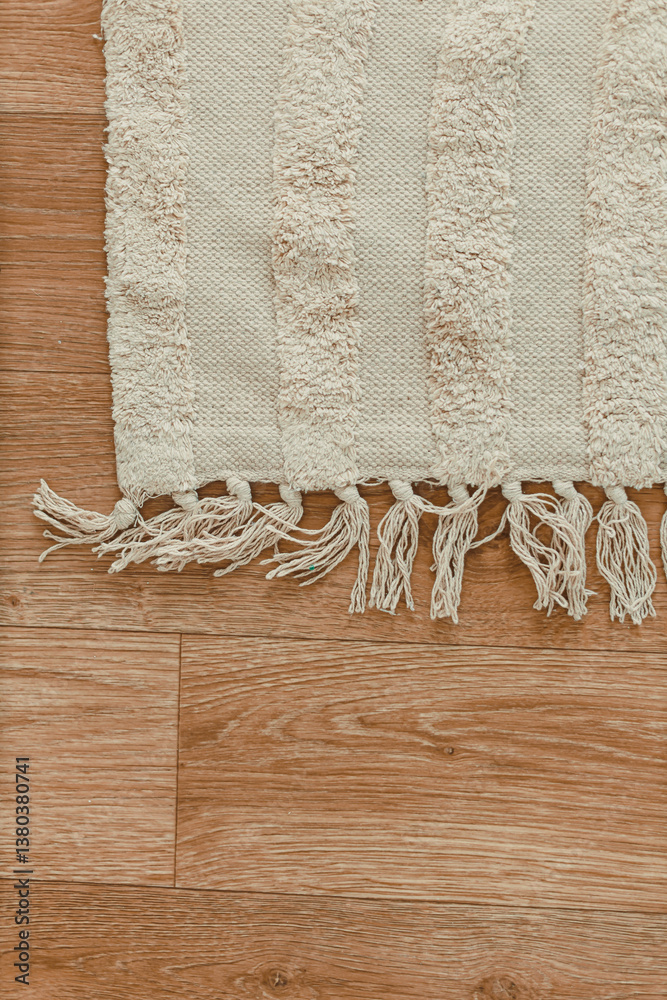 This soft textured area rug showcases beautifully fringed edges that span across a gorgeous wooden floor, making it perfect for adding warmth and comfort to enhance your living space beautifully