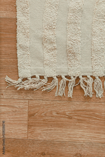 Obraz na płótnie This soft textured area rug showcases beautifully fringed edges that span across a gorgeous wooden floor, making it perfect for adding warmth and comfort to enhance your living space beautifully w salonie