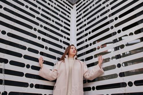 A young woman on the background of a wall