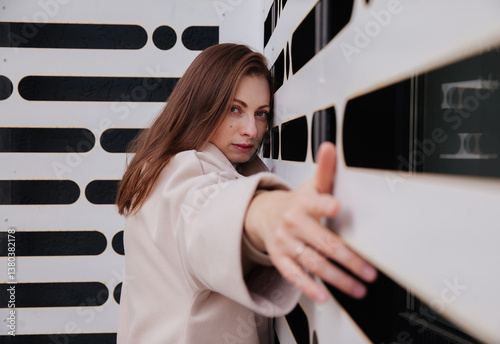 A young woman on the background of a wall