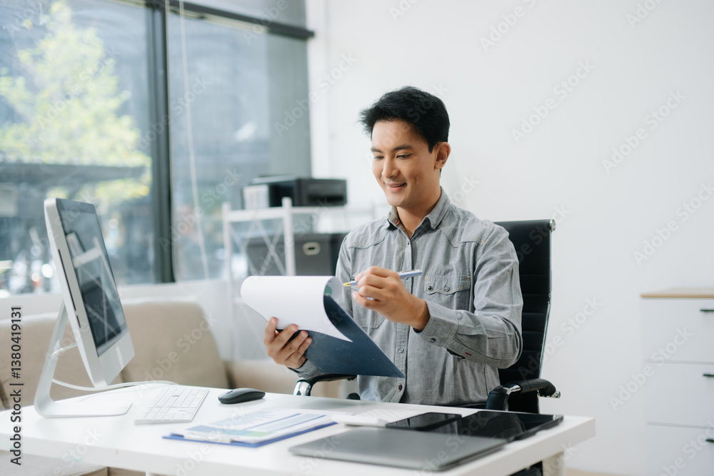 Confident businessman working on finance analysis with a tablet and laptop at office desk. Confident businessman working on finance analysis with a tablet and laptop at office desk.
