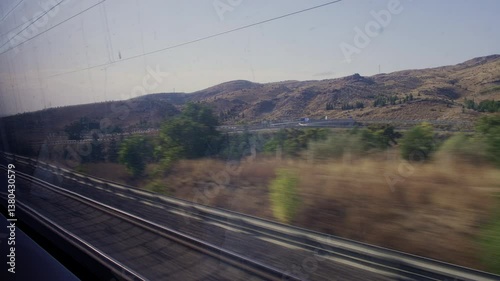 Real time footage of landscape outside of train window. View from inside train compartment
