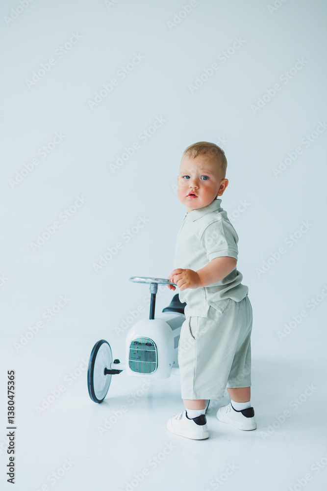 A Cute Toddler Engaging in Play with a Charming White Tricycle Capturing Joyful and Heartwarming Moments in a Beautifully Minimalist Studio Setting Filled with Simple Details and Soft Lighting A Cute Toddler Engaging in Play with a Charming White Tricycle Capturing Joyful and Heartwarming Moments in a Beautifully Minimalist Studio Setting Filled with Simple Details and Soft Lighting