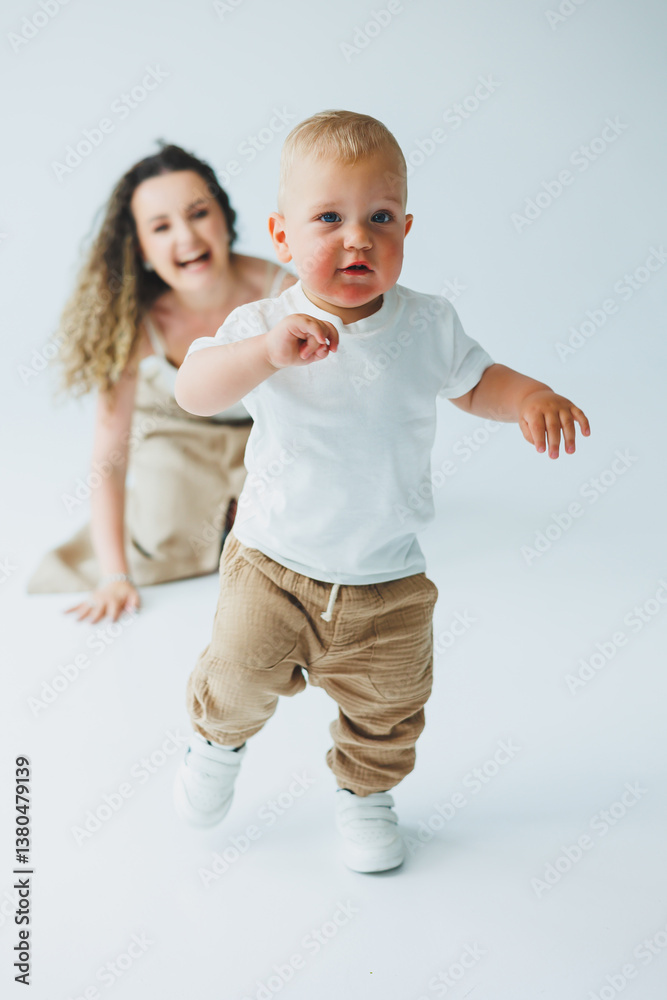 A joyful toddler runs with a delighted parent in a vibrant studio, creating laughter and love, highlighting the essence of childhood and the deep bonds formed through shared playful moments