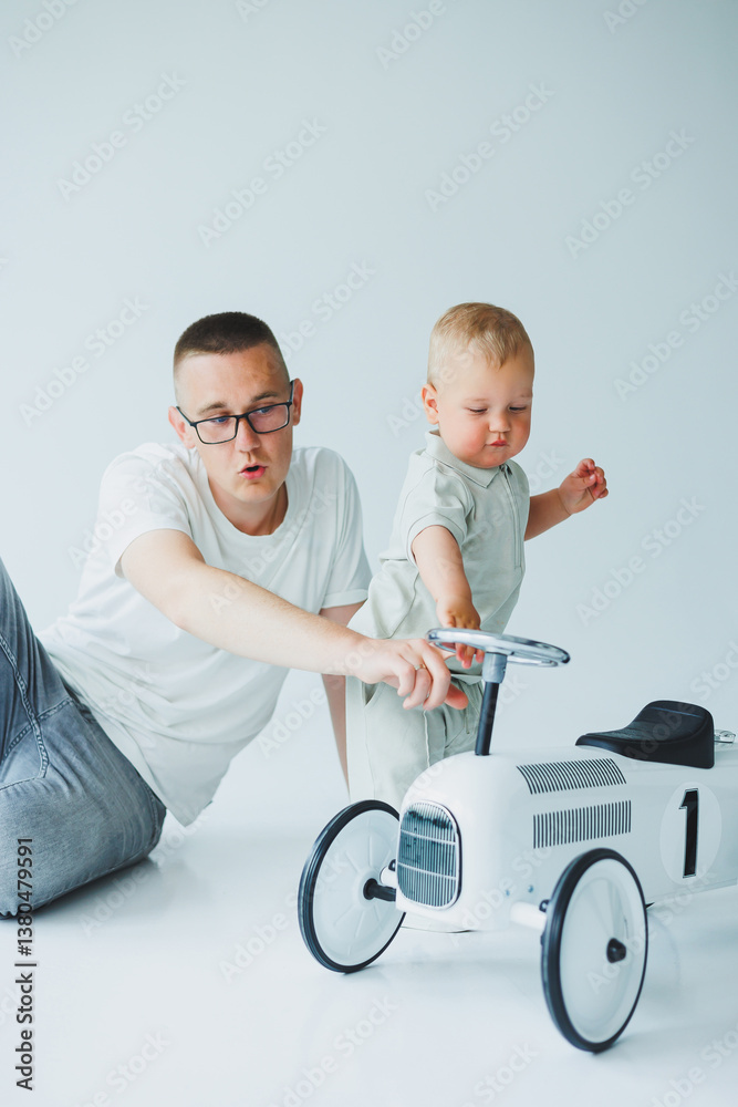 A Playful Bond A Father Actively Engaging with His Toddler Through a Classic Toy Car, Creating Moments of Joy and Laughter Together, while Celebrating the Innocence of Childhood and Family Life