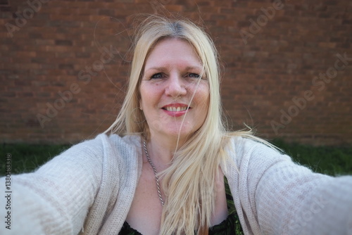 selfie portrait mature woman aged 50 plus British real people taking selfie smiling blonde hair 