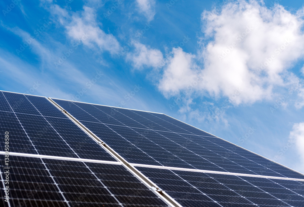 Solar energy industry background with big solar panel in front of blue sky. Solar energy industry background with big solar panel in front of blue sky.