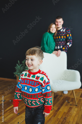 Obraz na płótnie A Joyful Child Wearing a Festive Sweater Surrounded by Family in the Background The Essence of the Holiday Spirit is Perfectly Captured in a Cozy and Inviting Setting During Winter Celebrations w salonie