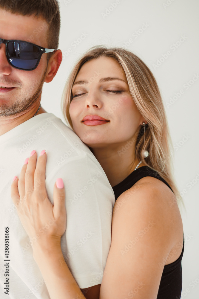A couple is embracing each other in a warm and heartfelt moment filled with affection, surrounded by a stylish and beautiful backdrop that enhances their loving connection and joyful intimacy