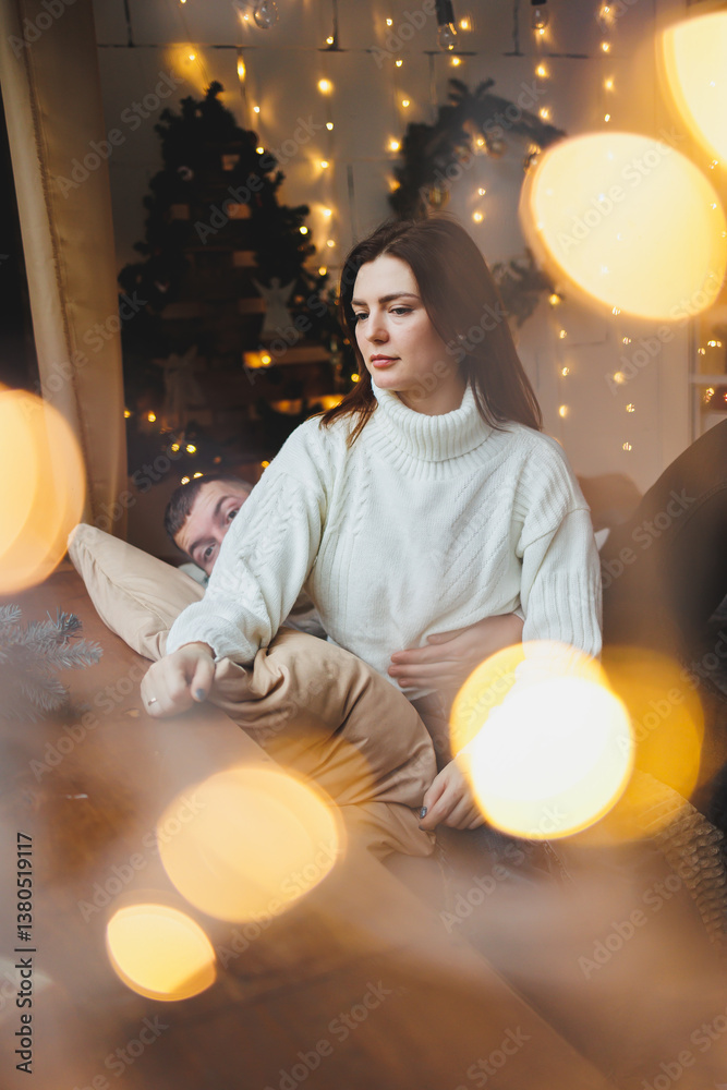 Cute girl in New Year's locations in a cozy living room. Woman at home for the new year.
