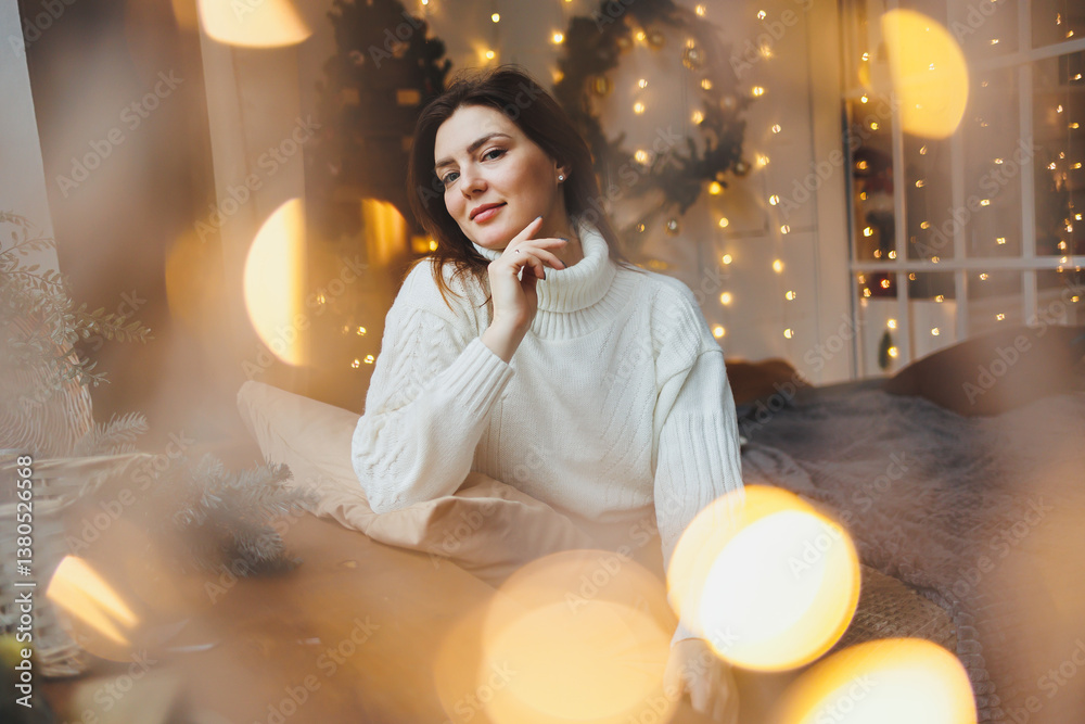 Cute girl in New Year's locations in a cozy living room. Woman at home for the new year.