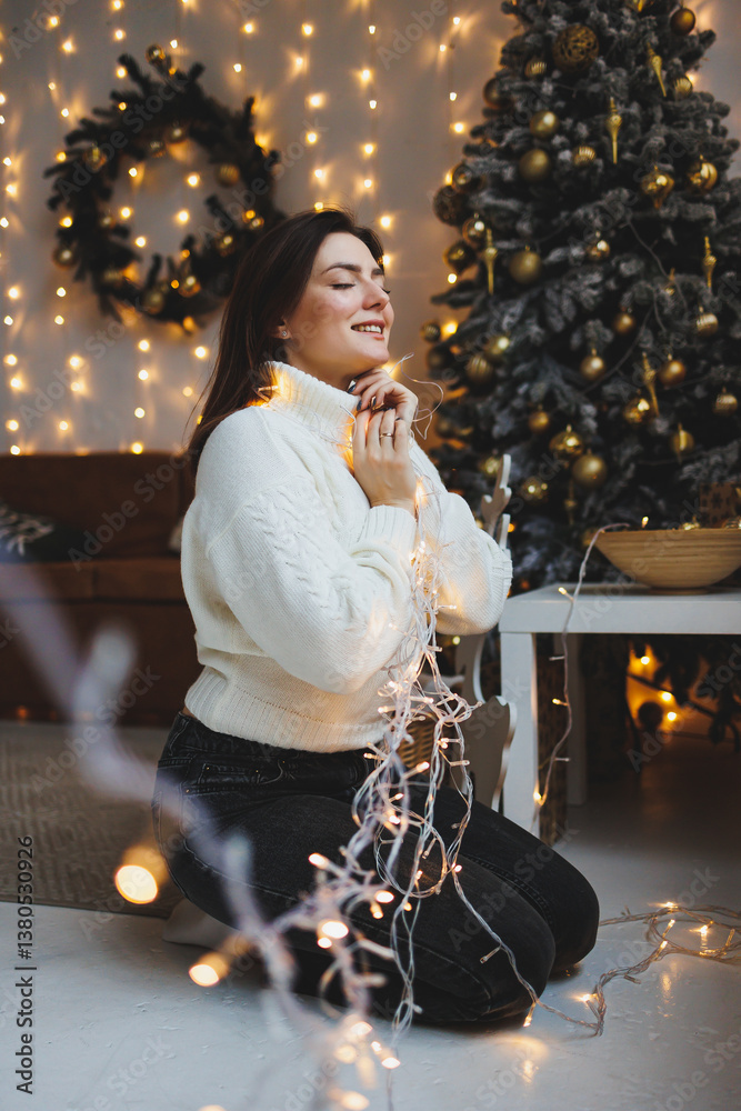 Cute girl in New Year's locations in a cozy living room. Woman at home for the new year.